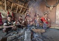 Hornbill Festival.Nagaland,India:2nd December 2016 : Konyak Tribal Man sitting by the fireplace at Hornbill Festival. Royalty Free Stock Photo