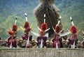 Hornbill Festival.Nagaland,India:1nd December 2013 : Naga Tribals performing tradition Dance outside their Morung at Hornbill Fest