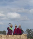 Hornbill Festival.Nagaland,India:1st December 2013 : Three Naga Tribals Sitting outside the Morong at Hornbill Festival Royalty Free Stock Photo