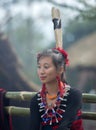 Hornbill Festival.Nagaland,India:1st December 2013 : Young Naga Lady sitting outside the morong  at Hornbill Festival. Royalty Free Stock Photo