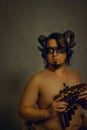 Faun with panflute Royalty Free Stock Photo