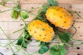 Horned melon, vine with two fresh ripe kiwano, Cucumis metuliferus, on wooden background Royalty Free Stock Photo