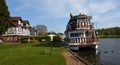 River boat cruiser moored on the river Bure at Horning next to the Swan Inn. Royalty Free Stock Photo