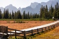 Hornischegg - Scenic hiking trail along wooden fence on alpine meadow on Nemes Alm (Rifugio Malga Nemes) in Carnic Alp Royalty Free Stock Photo