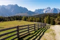 Hornischegg - Scenic hiking trail along wooden fence on alpine meadow on Nemes Alm (Rifugio Malga Nemes) in Carnic Alp Royalty Free Stock Photo