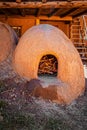 Horno, a mud adobe-built outdoor oven in Taos Pueblo New Mexico originally introduced to America by the Moors - filled with wood Royalty Free Stock Photo