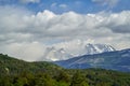 Horns of torres del paine towering over a mountain ridge, with dark green forest. Royalty Free Stock Photo