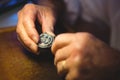 Horologist examining a clock part