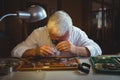 Horologist repairing a watch