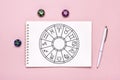 Horoscope circle with twelve signs of zodiac on paper, divination dice, colorful stone on pink background Fortune telling and