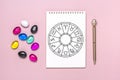 Horoscope circle with twelve signs of zodiac on paper, divination dice, colorful stone on pink background Fortune telling and