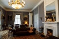 Horovice castle interior, Baroque chateau, carved wooden furniture in guest salon with sofa and armchairs, marble fireplace,