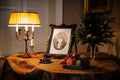 Horovice castle interior, Baroque chateau, Grand piano covered with embroidered tablecloth, vintage lamp, fruits, portrait in