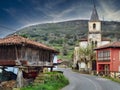 Horreo and church at Miyares village, next to El Sueve Sierra, Asturias, Spain