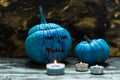 Horribly blue Halloween, painted blue pumpkins and candles