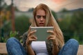 Horrified young woman staring wide-eyed at her tablet Royalty Free Stock Photo