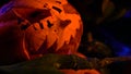 Horrifying monster holds a pumpkin while lights are blinking