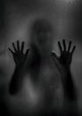 Horror ghost girl behind the matte glass in black and white. Hal Royalty Free Stock Photo