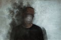 Horror and mental health concept. A mans head covered in smoke. With a blurred, grunge, abstract edit