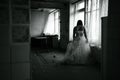 Horror night,ghost of bride in haunted house,mysterious woman in white dress standing in abandoned building