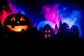 Horror view of Halloween pumpkin with scary smiling face. Head jack lantern with spooky building Royalty Free Stock Photo