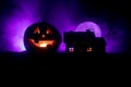 Horror view of Halloween pumpkin with scary smiling face. Head jack lantern with spooky building Royalty Free Stock Photo