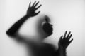 Horror woman behind the matte glass in black and white. Blurry h Royalty Free Stock Photo