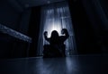 Horror woman in window wood hand hold cage scary scene halloween concept Blurred silhouette of witch. Selective focus Royalty Free Stock Photo