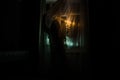 Horror woman in window wood hand hold cage scary scene halloween concept Blurred silhouette of witch. Selective focus Royalty Free Stock Photo