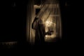 Horror woman in window wood hand hold cage scary scene halloween concept Blurred silhouette of witch. Selective focus