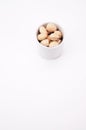 Snack time and appetizer concept - organic rosted pistachios in a white bowl on a white surface Royalty Free Stock Photo