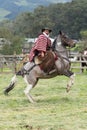 Horse back riding cowboy wearing furry chaps and wool poncho