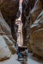 Horse buggy leave the Treasury through the Siq in Petra, Jordan Royalty Free Stock Photo