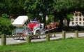 Horse carriage with horses traveling through park