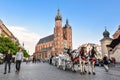 Horse carriage at main square in Krakow in a summer day, Poland. Two Horses In Old-fashioned Coach in front of St. Mary`s Basilic Royalty Free Stock Photo