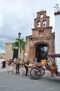 horse and carriage near the church with bells Royalty Free Stock Photo