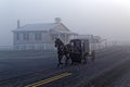 A Horse and Carriage Passes an Amish School House Royalty Free Stock Photo