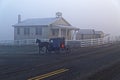 A Horse and Carriage Passes an Amish School House