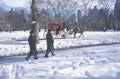Horse carriage ride and Sunday walkers in Central Park, Manhattan, NY after winter snowstorm Royalty Free Stock Photo