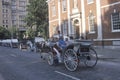 Horse and carriage riding in historic district of old Philadelphia, PA, in front of Independence Hall, home of Declaration of