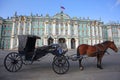 A horse & carriage waiting in Palace Square, Hermitage museum or Winter Palace , St Petersburg, Russia. Royalty Free Stock Photo