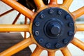 Horse carriage wheel with shiny wooden spokes and steel axel Royalty Free Stock Photo