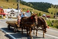 Horse carriage with wooden planks on mountain road in Bihor, Romania, 2021