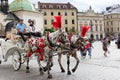 Horse carriages carry tourists for sight-seeing, Krakow, Poland