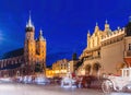 Horse carriages in the market square at the evening old town in Cracow, Poland Royalty Free Stock Photo