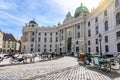 Horse carriages on St. Michael square Michaelerplatz at Hofburg palace, Vienna, Austria