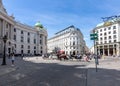 Horse carriages on St. Michael square Michaelerplatz near Hofburg palace, Vienna, Austria