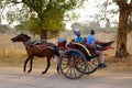 A horse cart carrying tourists on rural road in Bagan, Myanmar Royalty Free Stock Photo