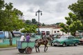 Horse cart and classic american car in Santiago de Cuba