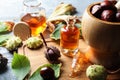 Horse chestnuts, leaves and bottles of tincture on grey table Royalty Free Stock Photo